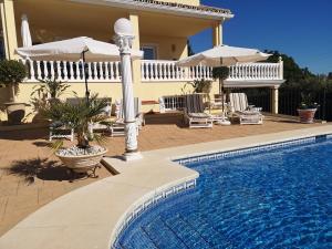 a swimming pool in front of a house at Roca Penthouse in Estepona