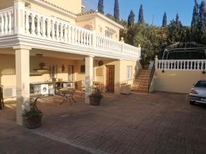a large house with a balcony and a patio at Roca Penthouse in Estepona