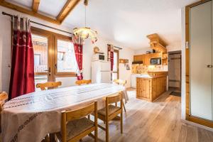 a kitchen with a table and chairs in a room at L'esterelle in La Plagne Tarentaise +14 photos