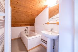 a bathroom with a sink and a bath tub at L'esterelle in La Plagne Tarentaise
