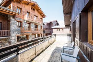 a balcony with a bench on the side of a building at L'esterelle in La Plagne Tarentaise