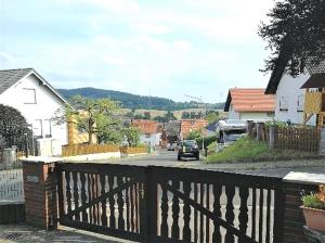 a view of a town with a wooden fence at Ferienwohnung Buedinger Weg in Gründau