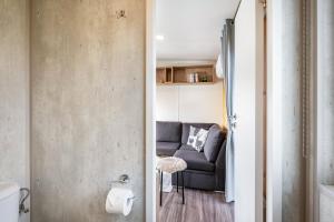 a living room with a couch in a room at Side-by-Side Tiny Houses in Untergriesbach +47 photos