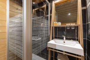 a bathroom with a sink and a shower at Chalet Velajule in Manigod +11 photos