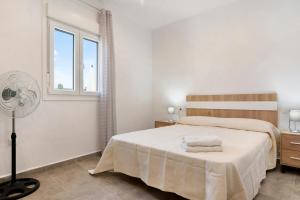 a white bedroom with a bed and a window at Villa Montenmedio - Paula in El Soto +17 photos