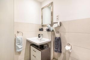 a bathroom with a sink and a mirror at Fewo Auszeit zum Anspel in Medebach +14 photos