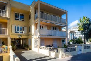 an apartment building with balconies on a street at Lagomar in Alcudia