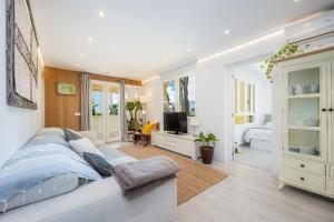 a bedroom with a large bed and a television at Lagomar in Alcudia