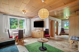 a living room with a couch and a table at Wein- und Klimahotel Bergfriedel in Bühlertal