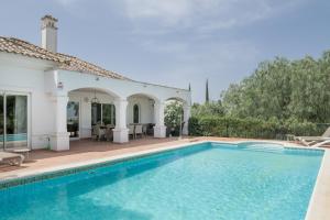 a swimming pool in front of a house at Luxury Villa Arcos Golf in Arcos de la Frontera