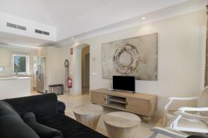 a living room with a couch and a tv at Luxury Villa Arcos Golf in Arcos de la Frontera