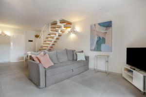 a living room with a couch and a staircase at Morada Ribes in Costa de Antigua