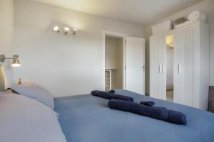 a bedroom with a blue bed with two pillows on it at Morada Ribes in Costa de Antigua +33 photos
