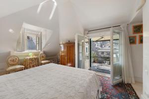 a bedroom with a large bed and a balcony at Attico Palazzo Giustiniani in Genoa