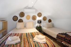 a attic room with two beds with towels on them at Casa River Sun in Valada +25 photos
