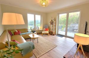 a living room with a couch and a table at Gittas Paradiesperle in Niederdreisbach