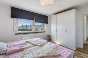 a bedroom with a pink bed and a window at Ferienwohnung Frank in Melschede