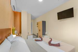 a hotel room with two snakes on the bed at 7A Hostal in Torrevieja
