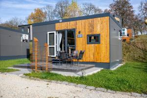 a tiny house with a table and chairs in a yard at Side-by-Side Tiny Houses in Untergriesbach