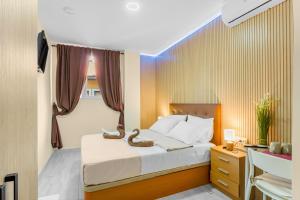 a bedroom with a bed and a desk with a laptop at 7A Hostal in Torrevieja +84 photos