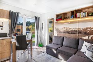 a living room with a couch and a desk at Side-by-Side Tiny Houses in Untergriesbach