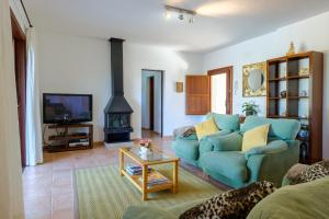 a living room with a blue couch and a fireplace at Can Ramon 1 in Sant Josep de sa Talaia