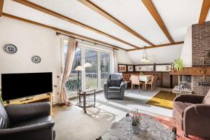 a living room with a flat screen tv and a living room at Ferienwohnung Grothoff in Olsberg