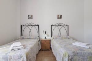 two beds sitting next to each other in a bedroom at Casa Nesenka 1 in Zahora +19 photos