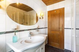 a bathroom with a sink and a mirror at Ferienwohnung Grothoff in Olsberg +17 photos