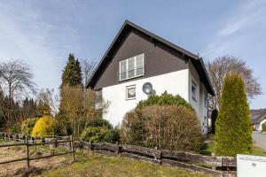 a white house with a black roof at Ferienwohnung Grothoff in Olsberg