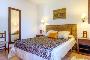 a bedroom with a bed and a mirror at Can Ramon 1 in Sant Josep de sa Talaia +24 photos