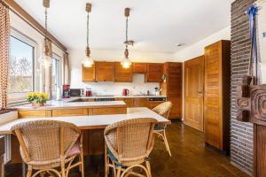 a kitchen with wooden cabinets and a table with chairs at Ferienwohnung Grothoff in Olsberg