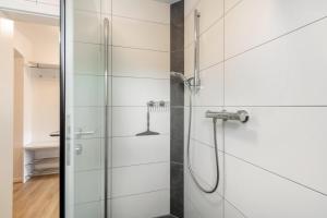a shower in a bathroom with a glass door at Ferienwohnung K5 in Wehr +19 photos