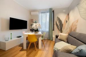 a living room with a table and a couch at Soleluna in Vado Ligure