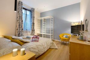 a bedroom with a bed and a desk and a television at Soleluna in Vado Ligure