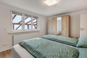 a bedroom with two beds and a window at Ferienwohnung K5 in Wehr