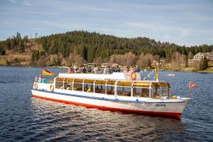 a boat full of people on the water at Haus Bergruh Kuckucksnest in Todtnauberg