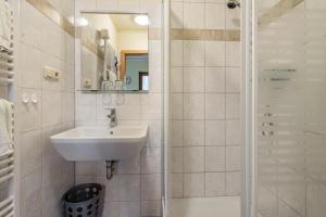 a bathroom with a sink and a shower at Pension Ufert in Meißen +22 photos