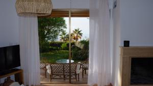 a living room with a sliding glass door to a patio at Villa Tropical Dream in Salobreña