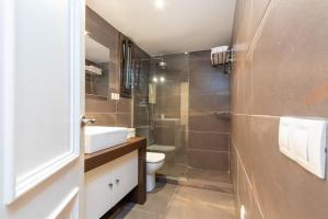 a bathroom with a toilet and a sink and a shower at Maria Beach in Platja d'Aro +13 photos