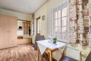a dining room with a table and a window at Pension Ufert in Meißen