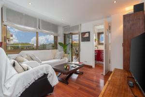 a living room with a white couch and a table at Maria Beach in Platja d'Aro