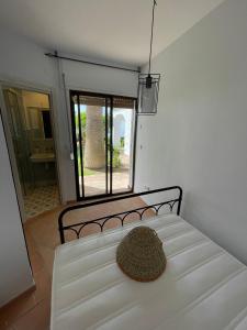 a bed with a hat sitting on top of it at Villa Tropical Dream in Salobreña +17 photos