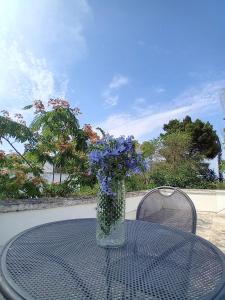 a vase of flowers sitting on top of a table at Sud e Sole in Lecce