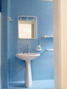 a bathroom with a white sink and a mirror at Sud e Sole in Lecce