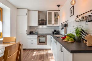a kitchen with white cabinets and a counter top at Haus Bergruh Kuckucksnest in Todtnauberg