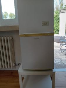 a refrigerator sitting on a table in a room at Sud e Sole in Lecce
