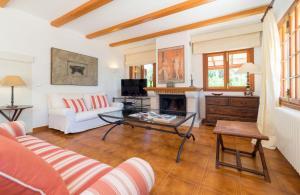 a living room with a couch and a fireplace at Sembat de Mar in Cala Millor