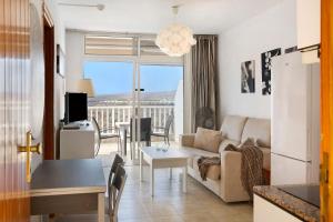 a living room with a couch and a table at Balcón de Amadores - Beach view in Puerto Rico de Gran Canaria