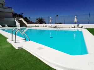 a large swimming pool with blue water at Balcón de Amadores - Beach view in Puerto Rico de Gran Canaria